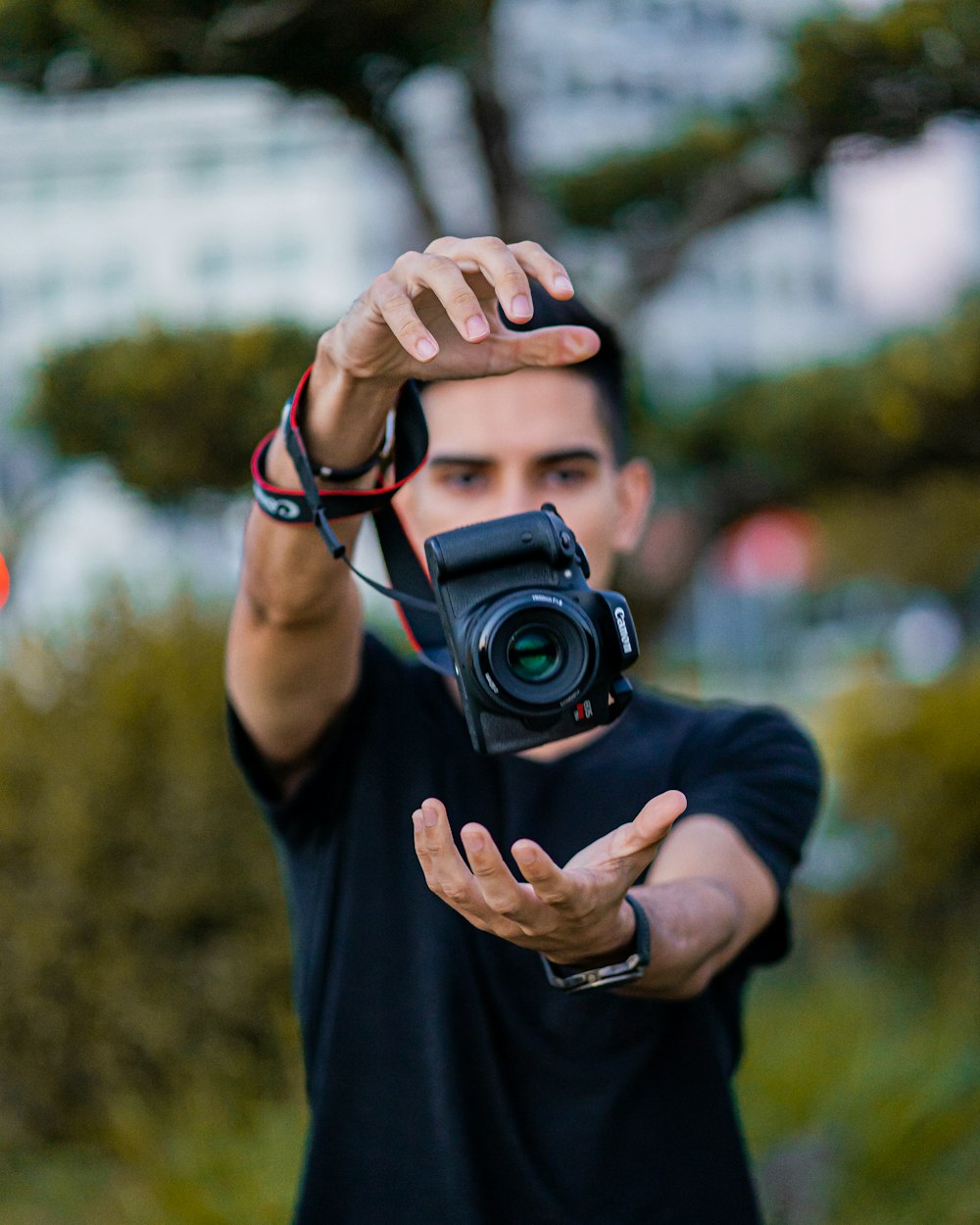 a man holding a camera up to take a picture