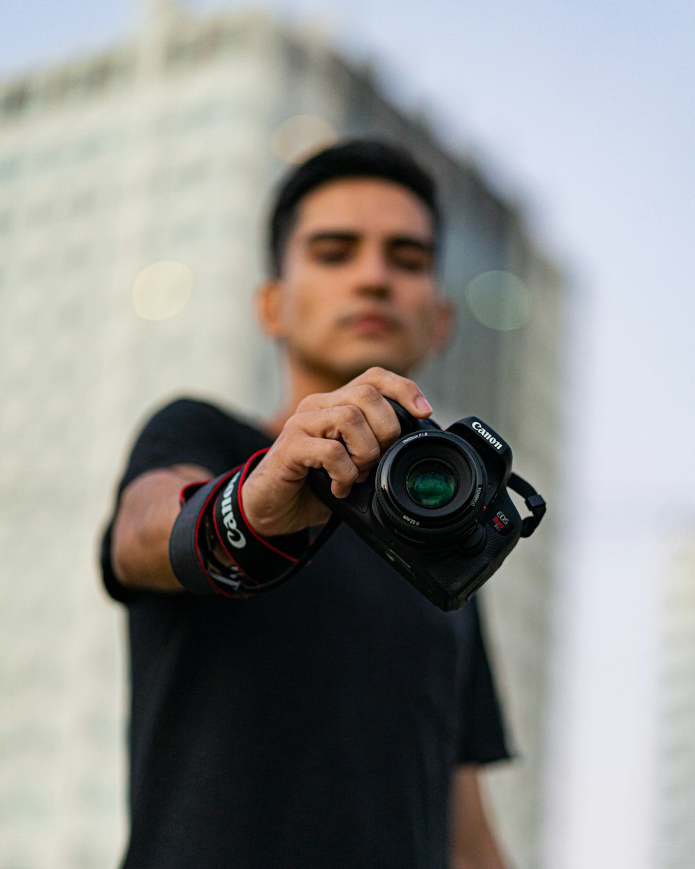 a man holding a camera in his right hand