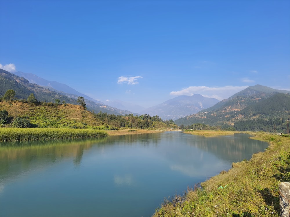 a body of water with mountains in the background