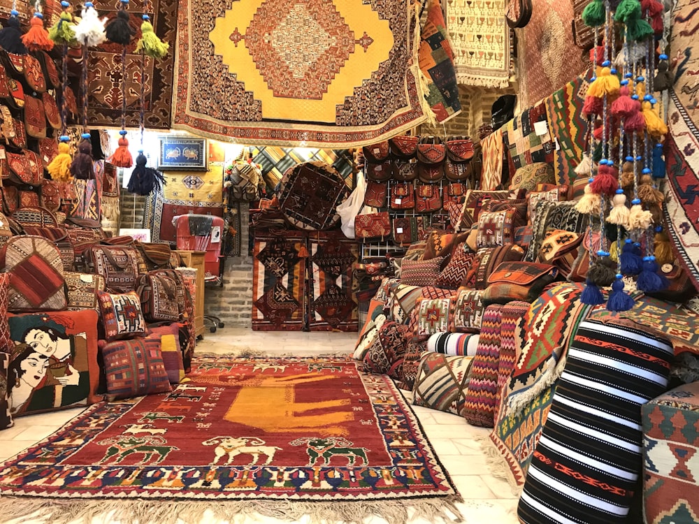 a room filled with lots of colorful carpets and rugs