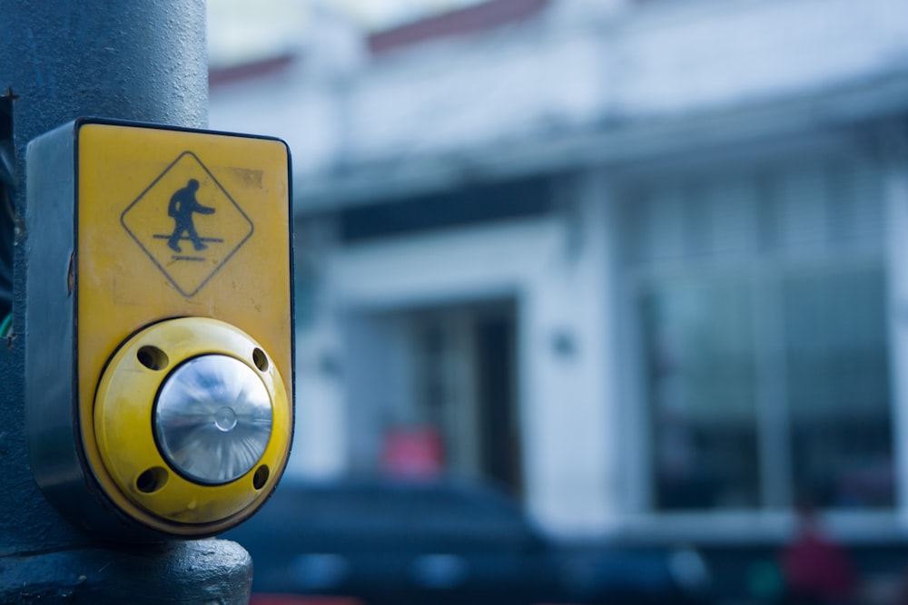 a walk sign on a pole in front of a building