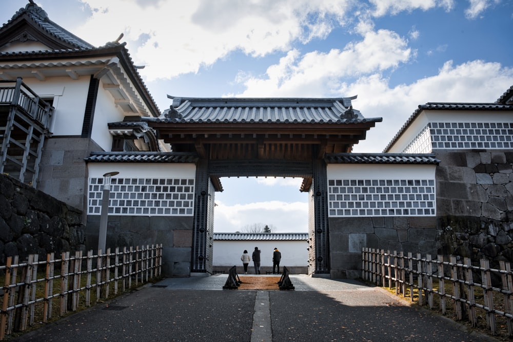 a couple of people that are standing in front of a gate