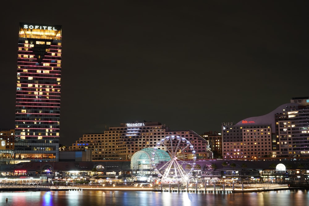 a city skyline with a ferris wheel in the foreground