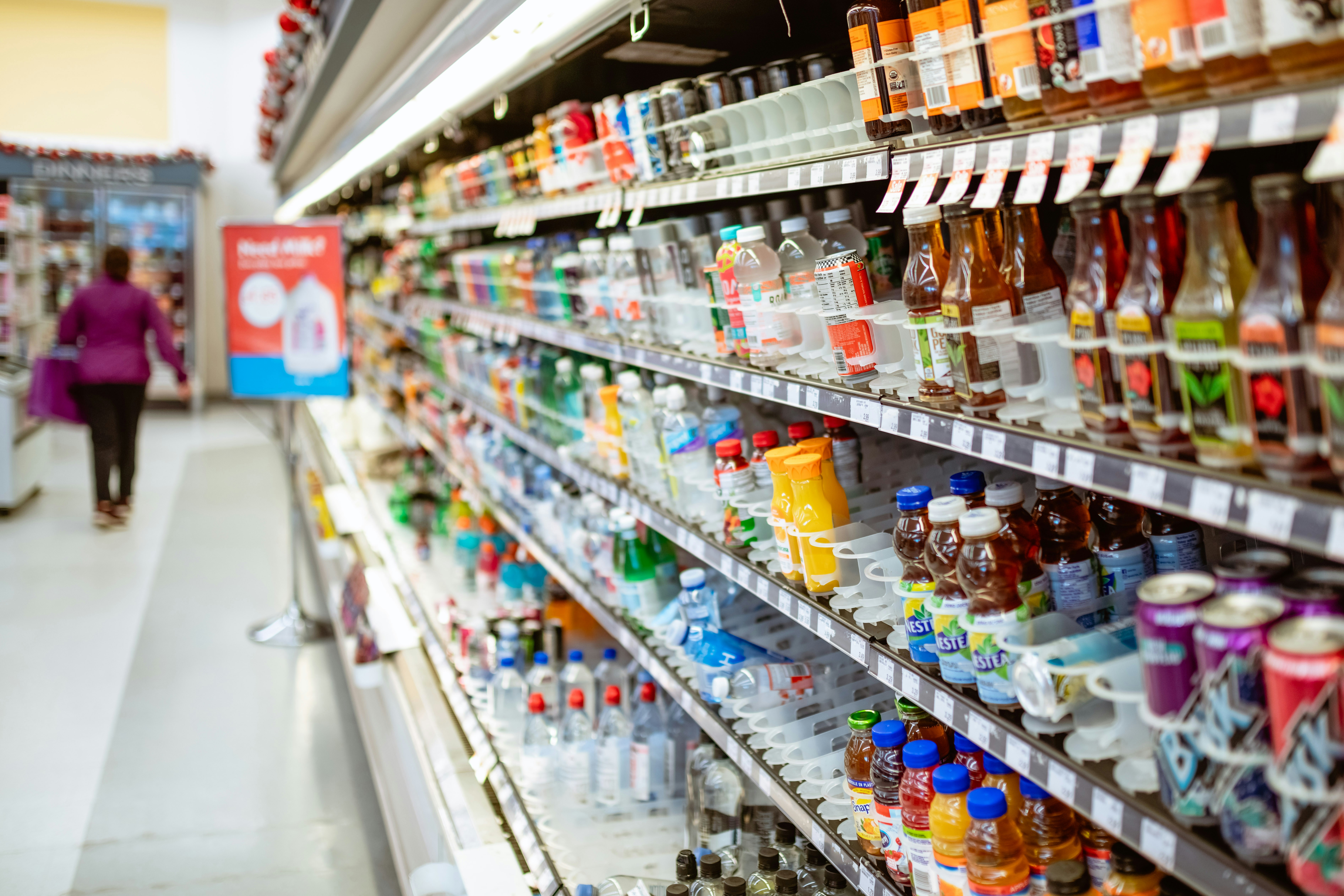 Assorted beverages and drinks in colorful packaging on bright retail shelves