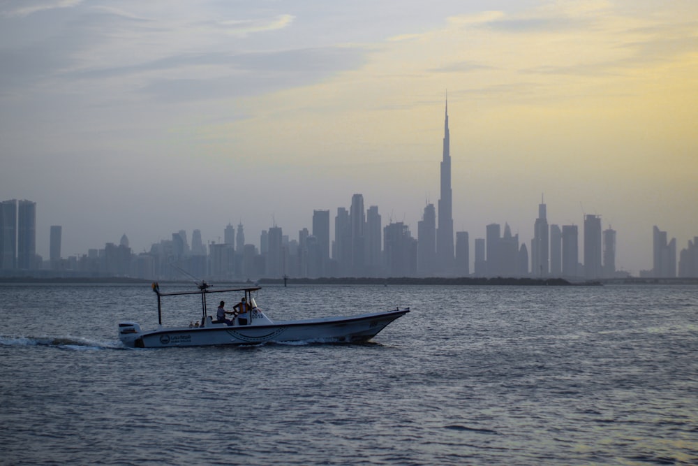 a boat in the water with a city in the background