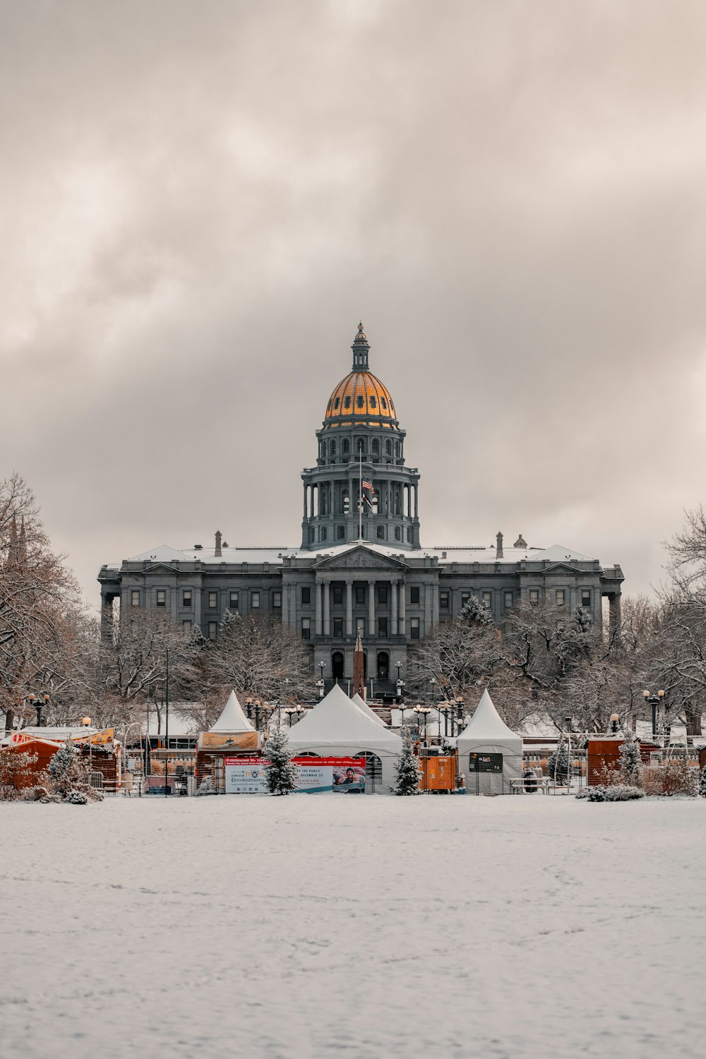 a large building with a dome in the middle of a snowy field