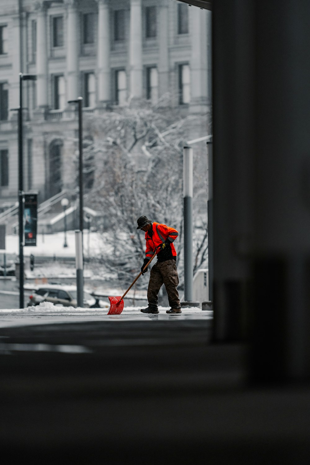 a man sweeping the street with a broom