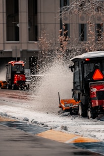 a street sweeper cleaning snow from the sidewalk