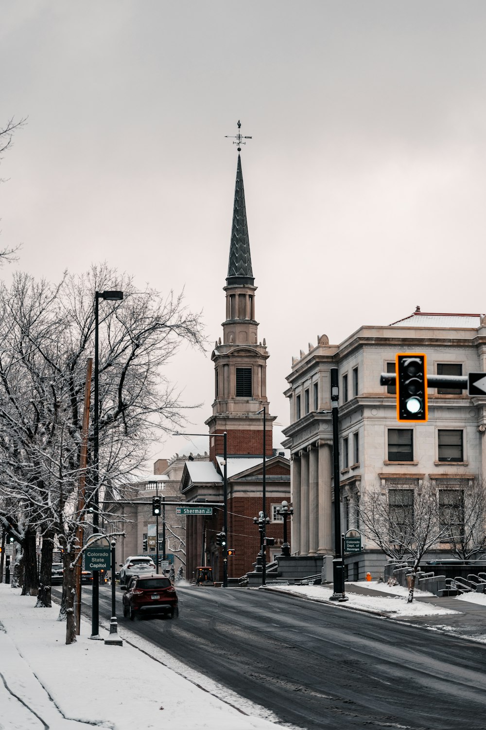 a traffic light sitting on the side of a snow covered road