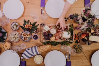 a wooden table topped with plates of food