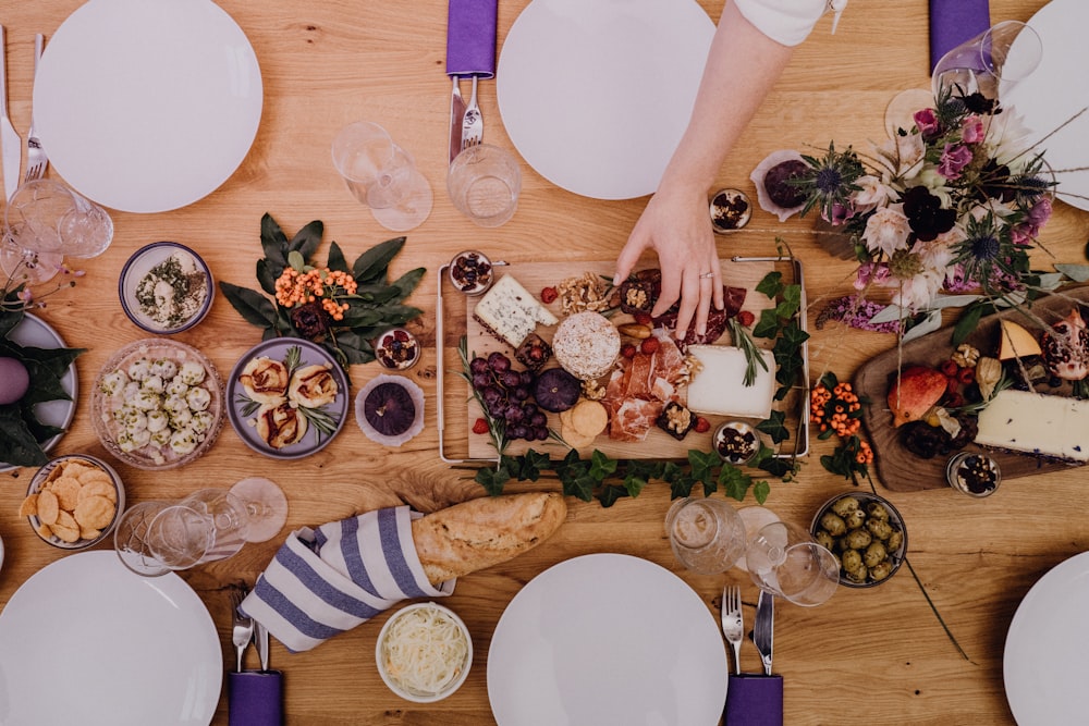 a wooden table topped with plates of food