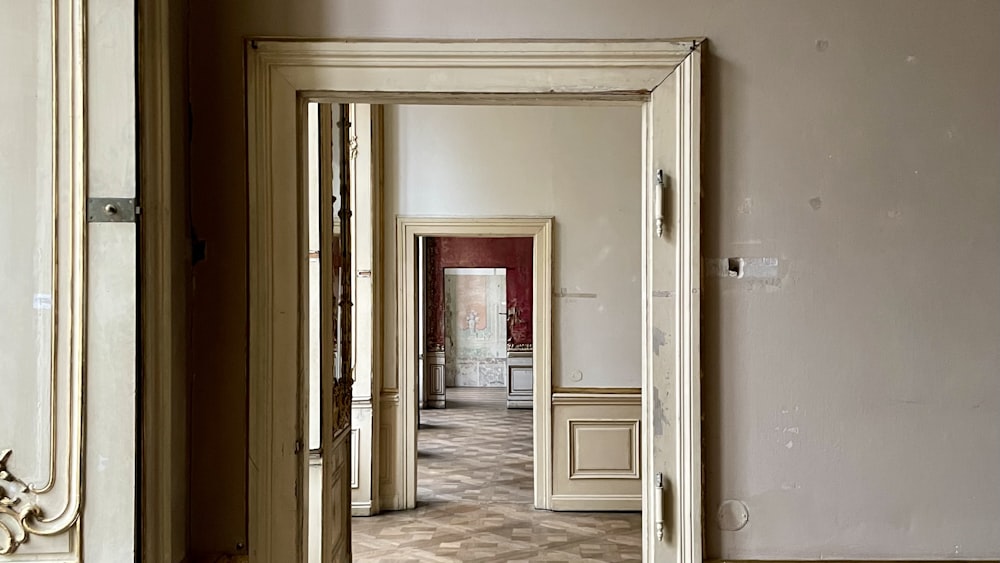 an empty room with a door and a mirror