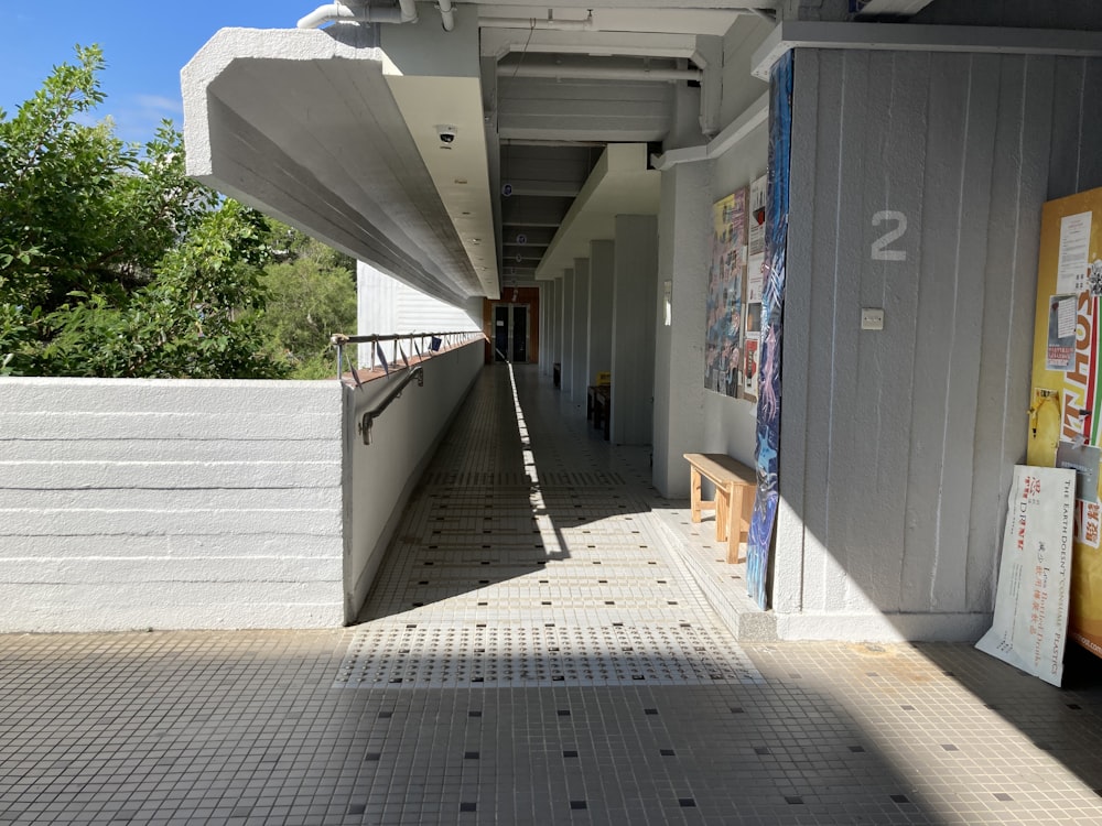 a long hallway with a bench on the side of it