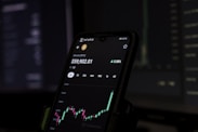 a cell phone displaying a stock chart on the screen
