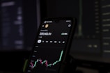 a cell phone displaying a stock chart on the screen