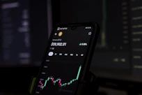 a cell phone displaying a stock chart on the screen