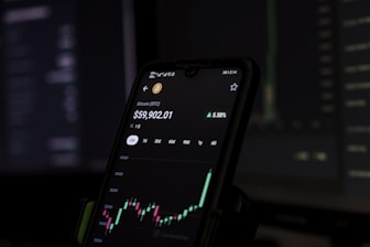 a cell phone displaying a stock chart on the screen