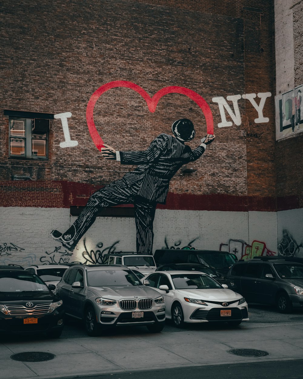 a mural of a man in a suit is on the side of a building