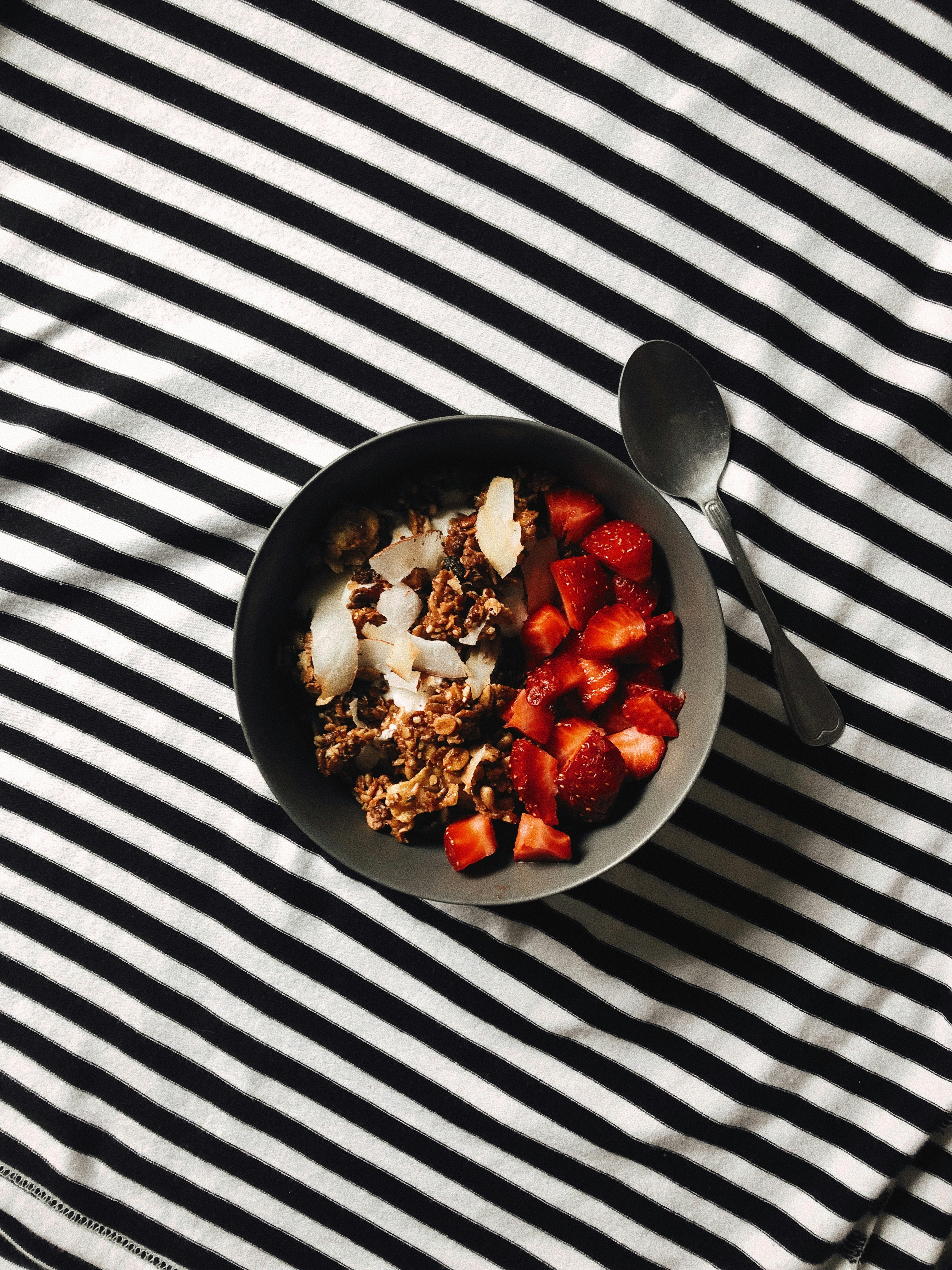 a bowl of granola with strawberries and yogurt