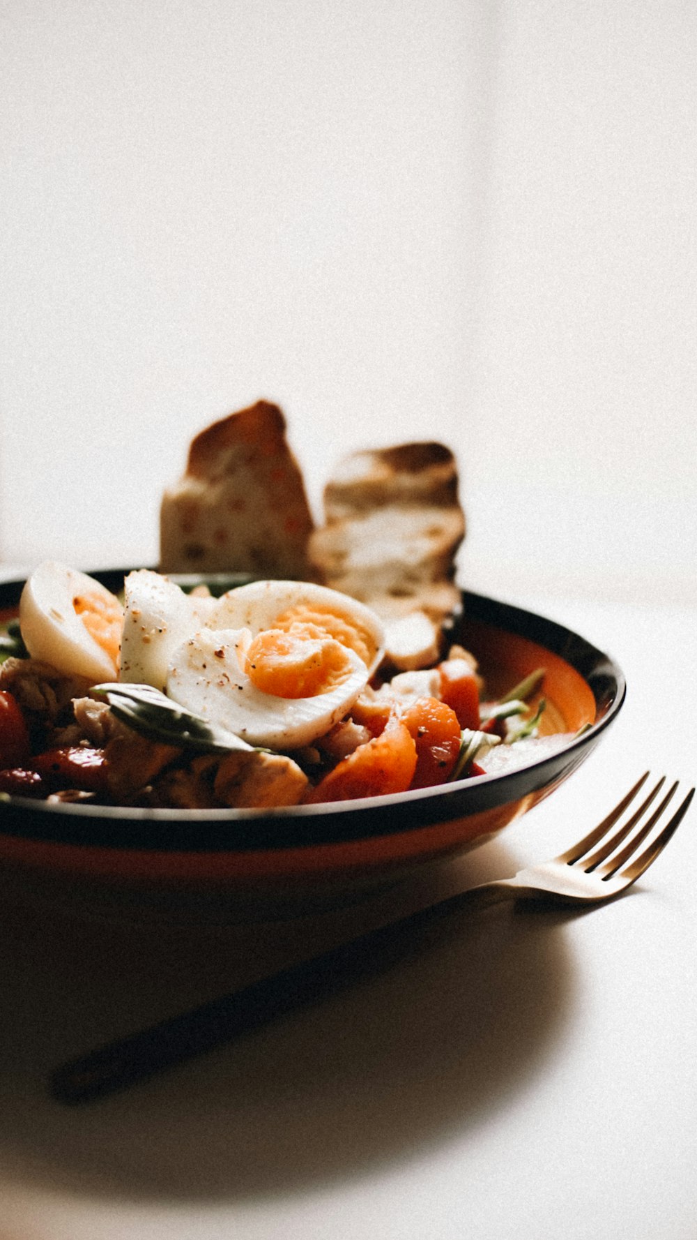 a bowl of food on a table with a fork