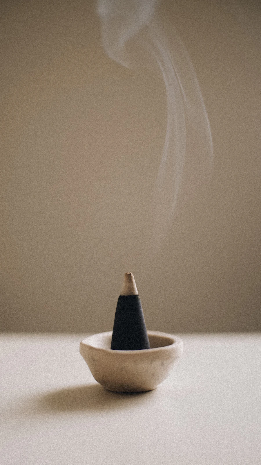 Sacred incense smoke rising from brass bowl