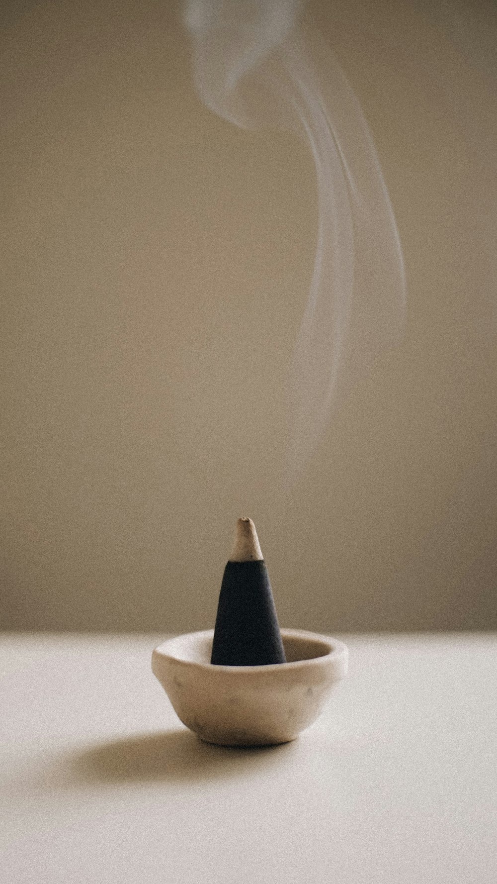 a smokestack sitting in a bowl on a table
