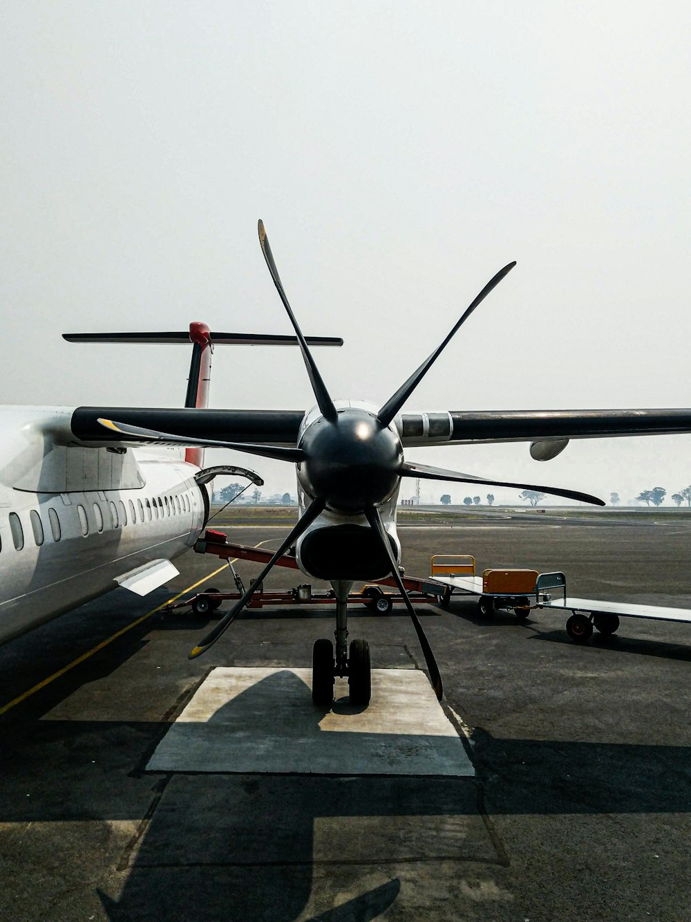a large propeller plane sitting on top of an airport tarmac