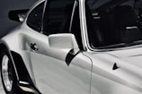 Side view of a sleek car with freshly detailed paintwork.