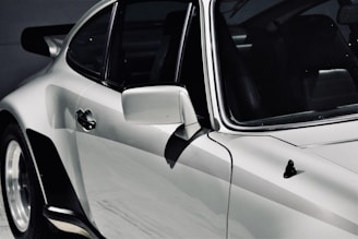 Side view of a sleek car with a mirror-like finish after detailing.