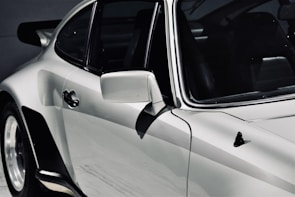 Side view of a sleek car with freshly detailed paintwork.