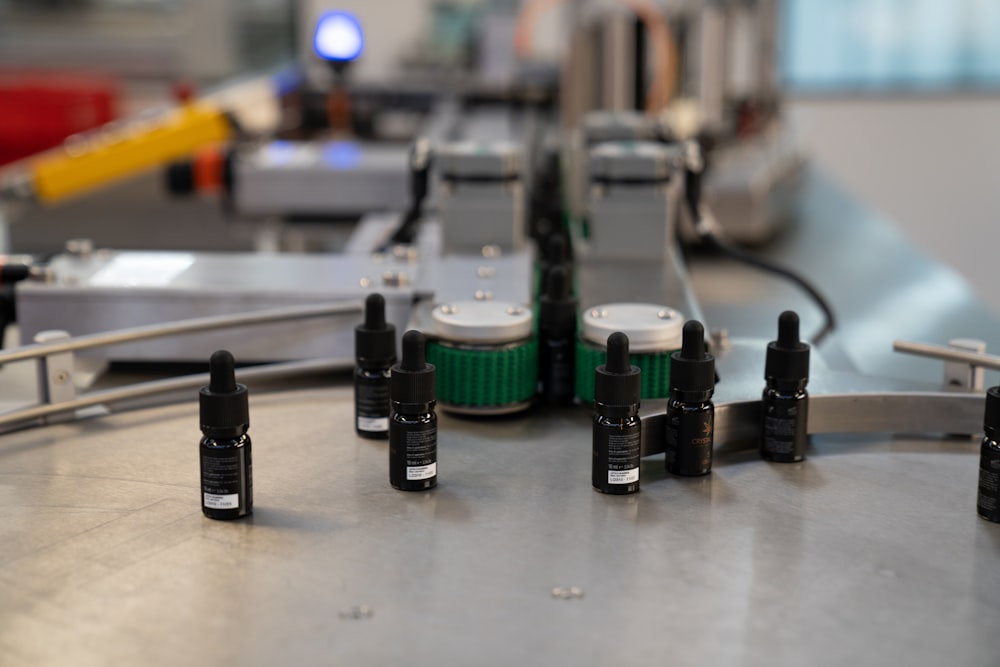 a group of bottles sitting on top of a metal table