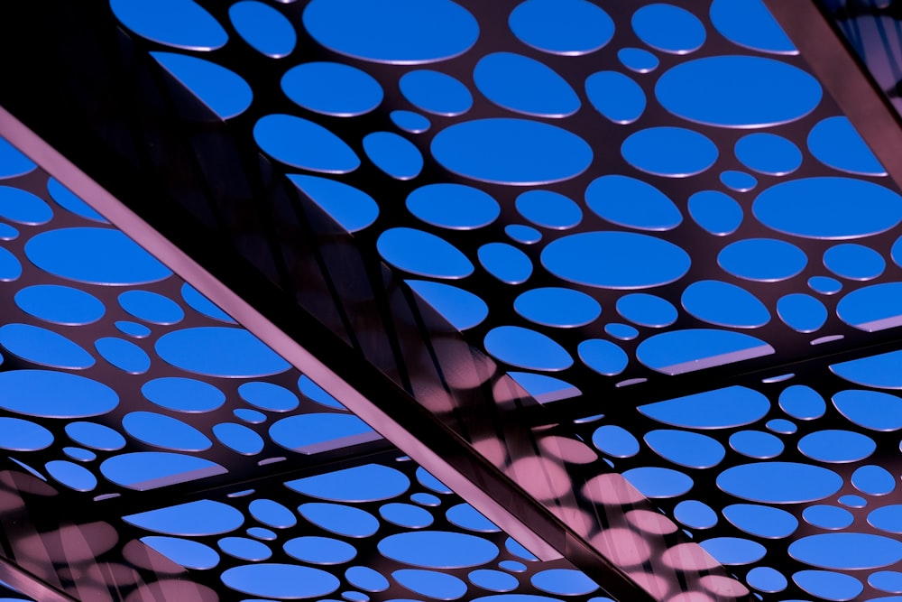 a close up of a metal structure with a blue sky in the background