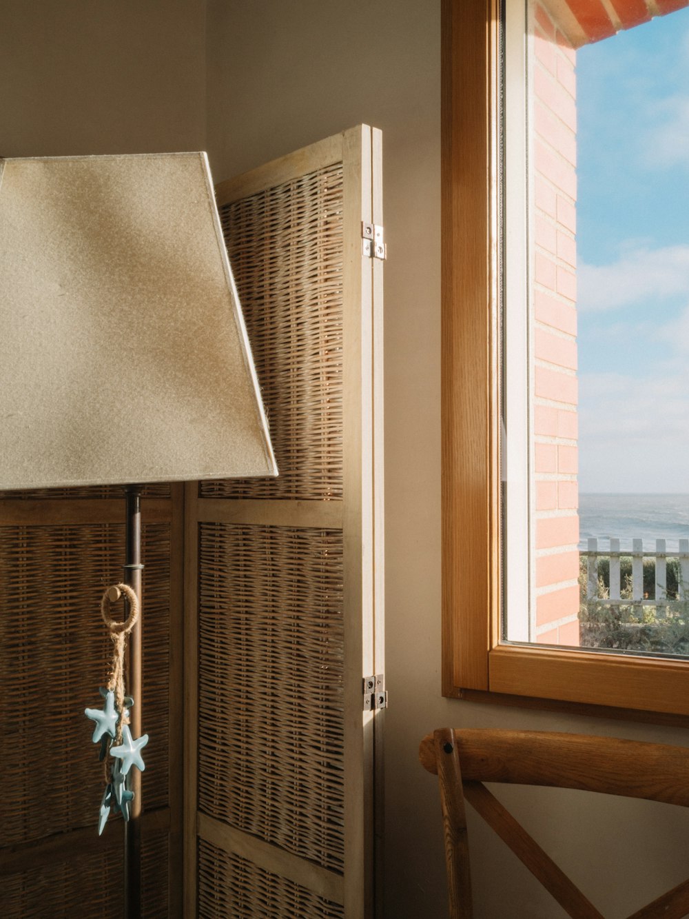 a lamp sitting on top of a table next to a window