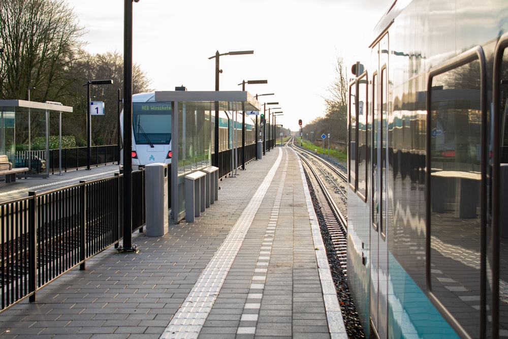 a train pulling into a train station next to a platform