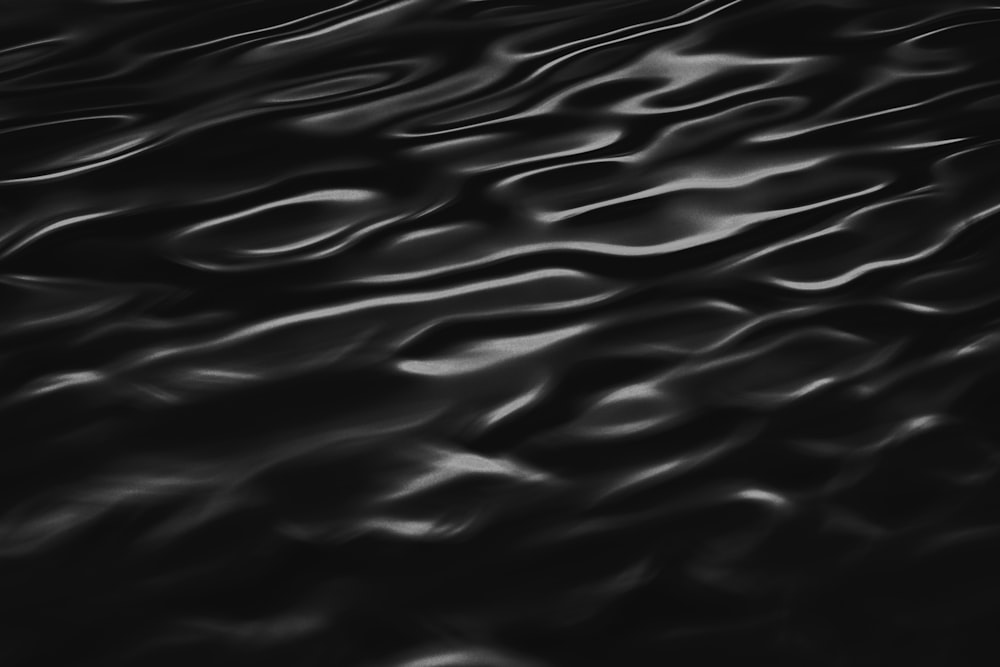 a black and white photo of wavy water