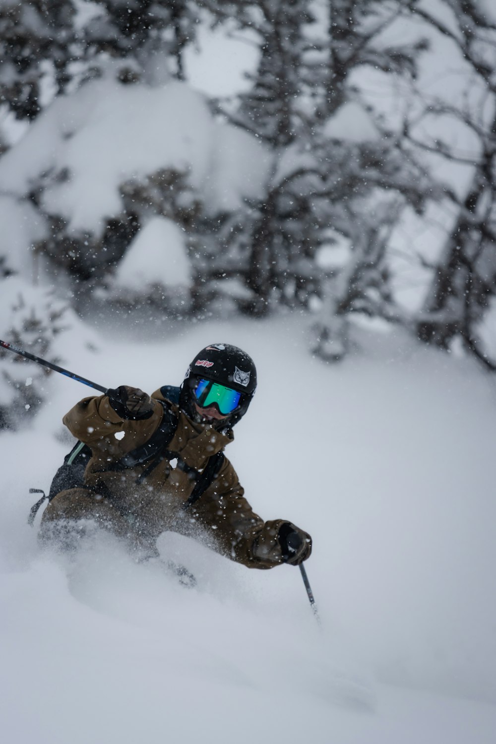 a man riding skis down a snow covered slope