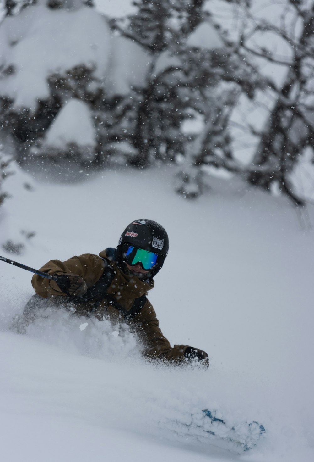 a man riding skis down a snow covered slope