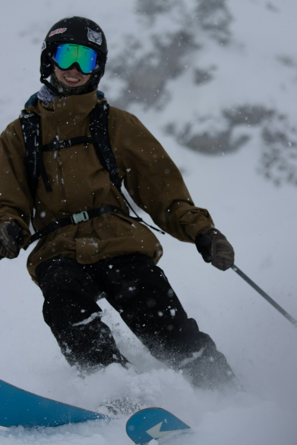 a man riding skis down a snow covered slope