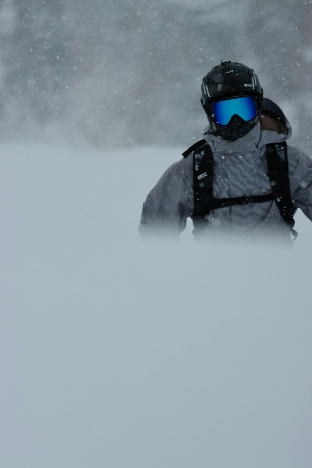 a person wearing a helmet and goggles in the snow