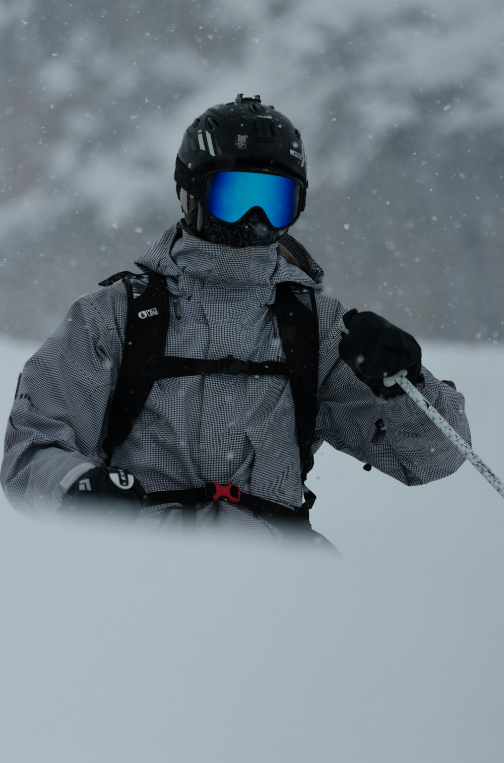 a person with a backpack and skis in the snow