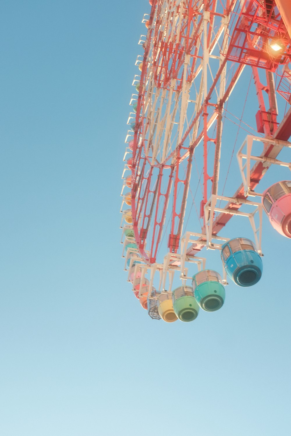 a ferris wheel with four buckets hanging from it