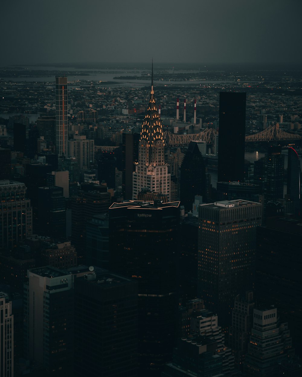 a view of a city at night from the top of a skyscraper