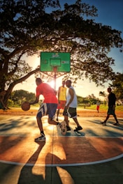 a group of young men playing a game of basketball
