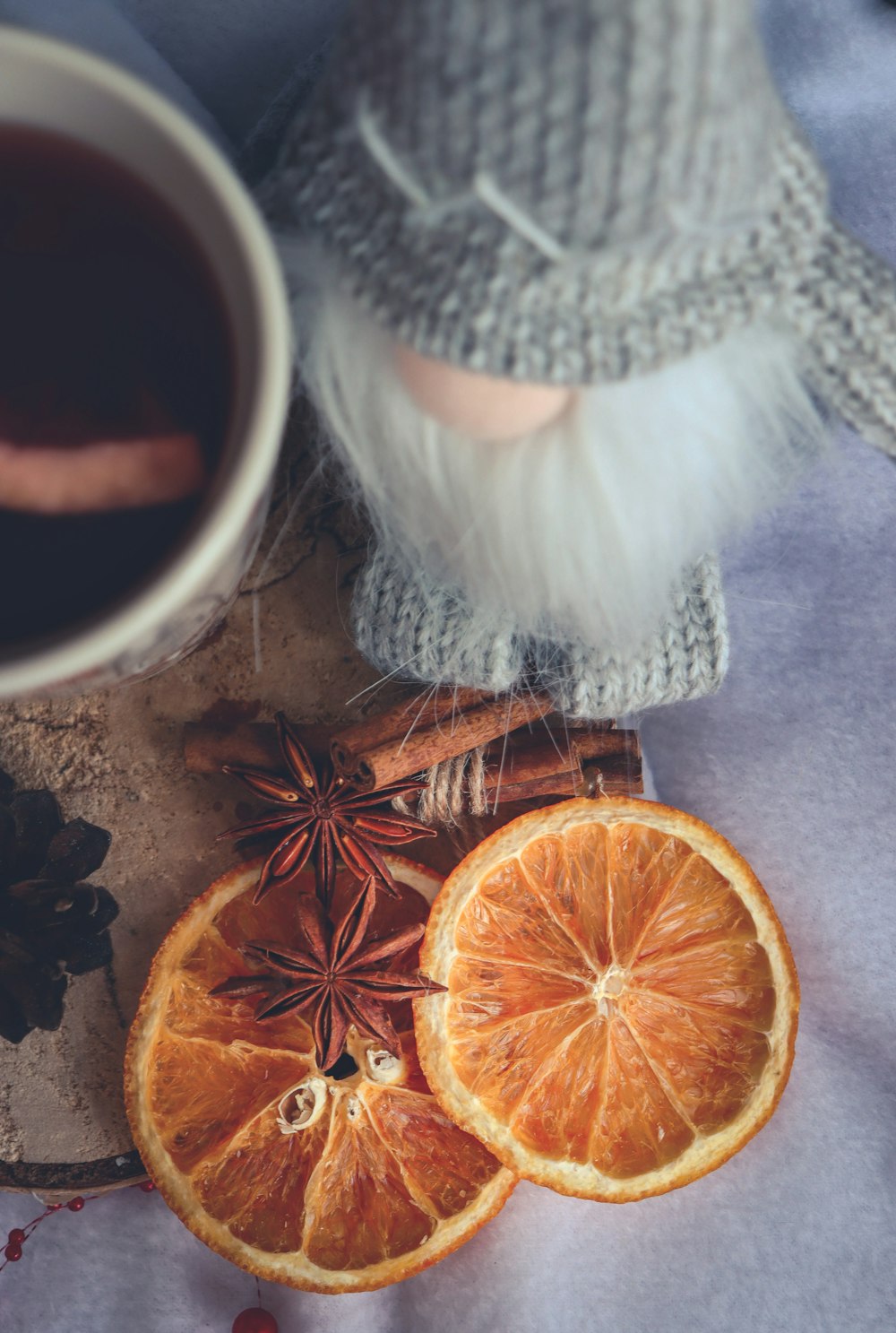 a cup of tea next to an orange cut in half