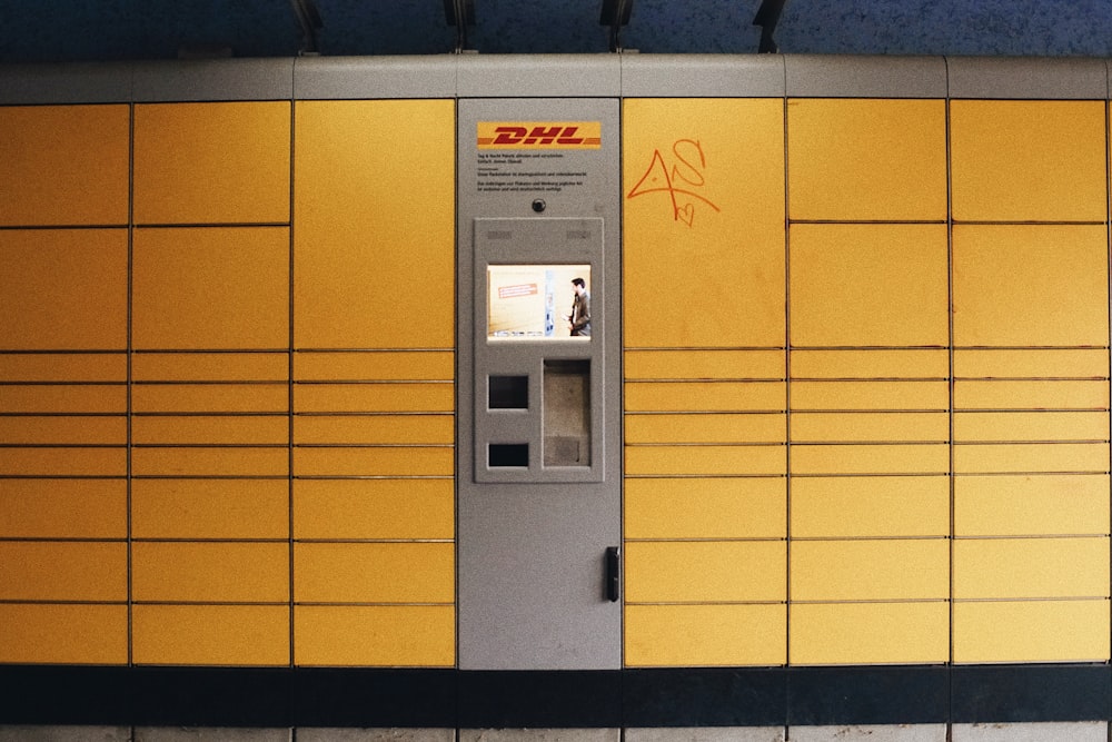 a yellow and gray atm machine in a building
