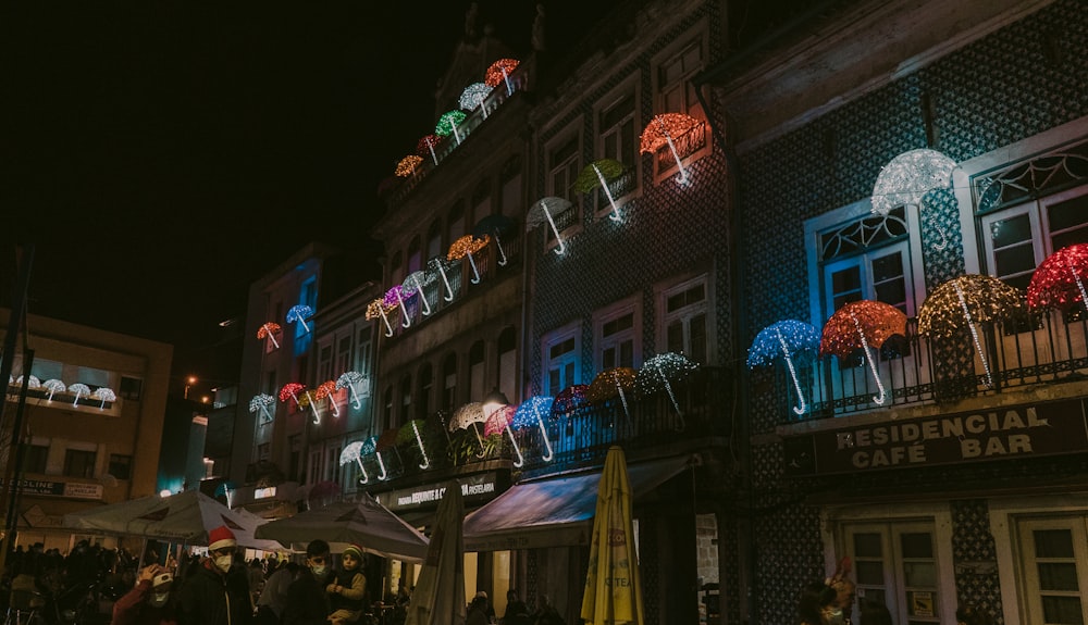 a group of people standing outside of a building at night