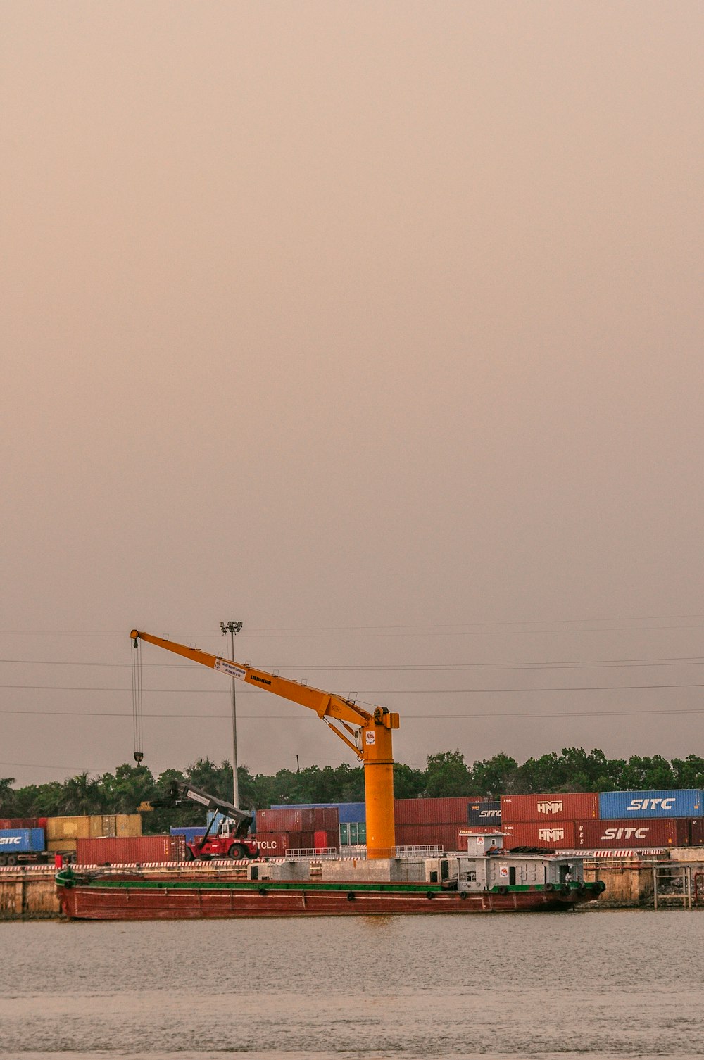 a crane is on the side of a large body of water