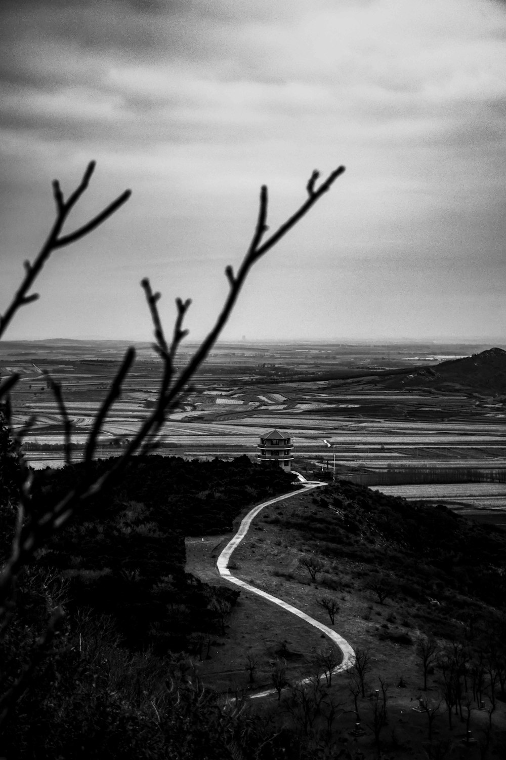 a black and white photo of a winding road