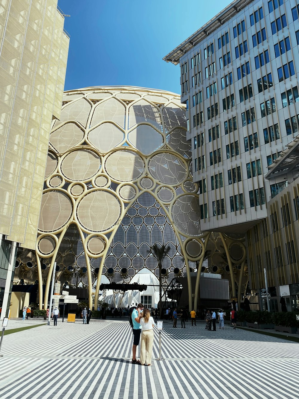 a couple of people standing in front of a building