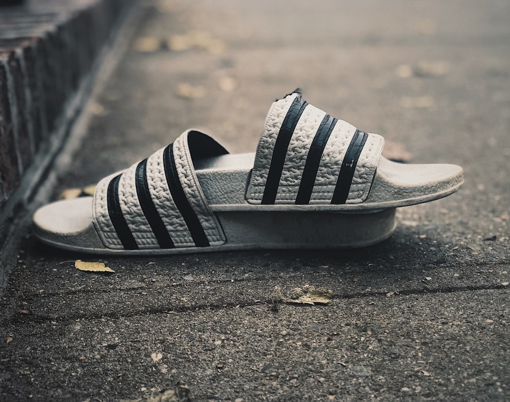 a pair of black and white shoes laying on the ground